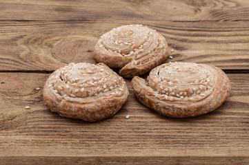 Biscuits with sesame seeds on a wooden table
