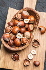 Filberts or hazelnuts in the wooden bowl on the table.