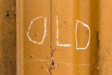Old handwriting with chalk on orange metal background