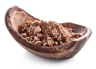 Cocоa powder or carob powder in wooden bowl on white background.