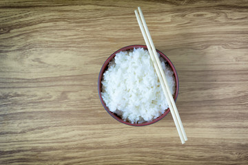 Rice hot chopsticks in a bowl of black on wooden floor