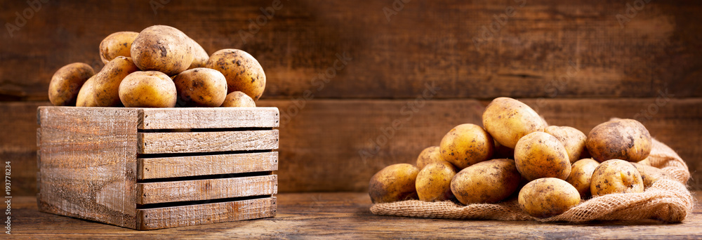 Sticker fresh raw potatoes in a wooden box - Stickers