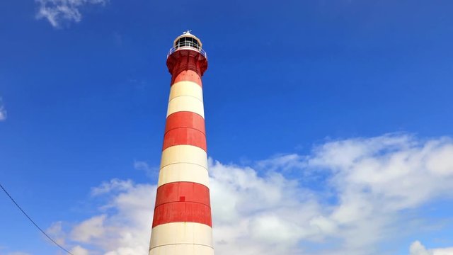 Iconic Moore Lighthouse Point on blue sky in Geraldton, Western Australia. The historic steel tower is built in 1878. Blue sky copy space in time lapse.