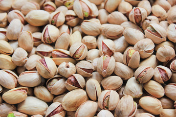 Pistachio Nuts Texture Background Top View. Pile of Fresh Green Pistachios, Roasted and Salted in Shell. Healthy Nuts with High Nutrition Ingredients, Close Up Pattern.