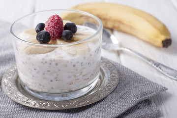 Smoothies with chia seeds and oat flakes with banana and frozen blueberries and raspberries