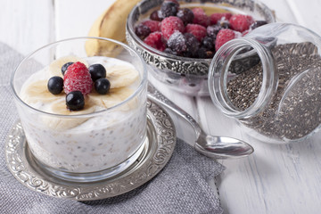 Smoothies with chia seeds and oat flakes with banana and frozen blueberries and raspberries