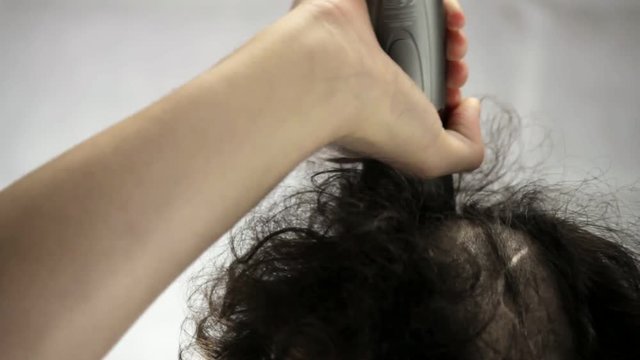 A men shaves head closeup