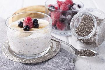Smoothies with chia seeds and oat flakes with banana and frozen blueberries and raspberries