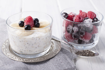Smoothies with chia seeds and oat flakes with banana and frozen blueberries and raspberries