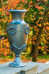 Vase closeup on the background of trees with dry leaves in Arboretum, Sochi, Russia
