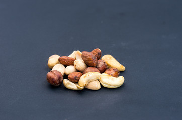 A variety of nuts on a black background.