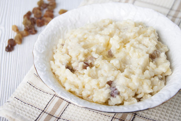 Millet porridge with raisins in a white plate