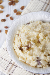 Millet porridge with raisins in a white plate
