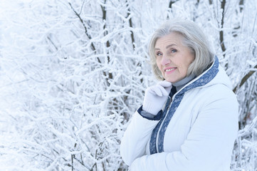 mature woman in winter posing outdoors