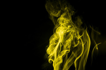 Yellow smoke on black background