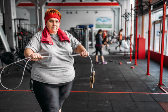 Fat sweaty woman, fitness exercise with rope