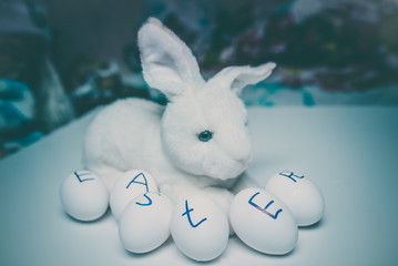 Eggs with the inscription of a happy Easter with rabbit (bunny)