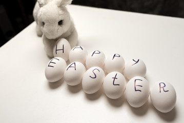 Eggs with the inscription of a happy Easter with rabbit (bunny)