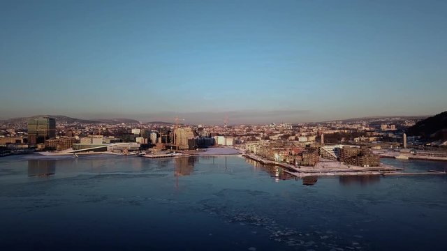 Aerial crane shot of Lambda Munch museum, Opera and houses in Sorenga in Oslo, Norway in winter