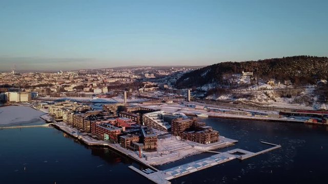 Aerial crane shot of Lambda Munch museum, Opera and houses in Sorenga in Oslo, Norway in winter