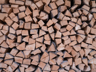 Wall of chopped logs saved for winter fire or heating.