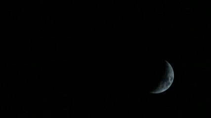 Obraz na płótnie Canvas A half moon down in the right corner. Crescent phase.