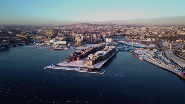 Aerial crane shot of Lambda Munch museum, Opera and houses in Sorenga in Oslo, Norway in winter