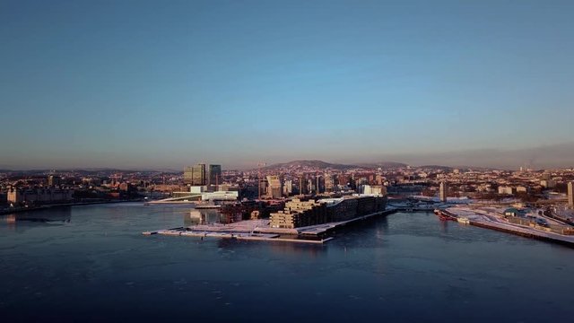Aerial crane shot of Lambda Munch museum, Opera and houses in Sorenga in Oslo, Norway in winter