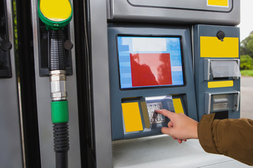 Self-service filling station. A man pays for fuel with a credit card