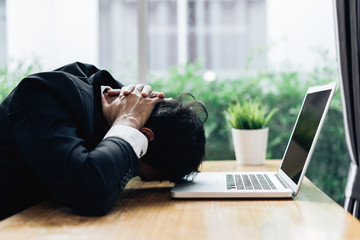 Businessman failure project plan deadline serious emotion and depression or deadline at office room with laptop computer report on working table