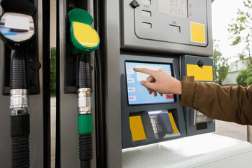 Self-service filling station. The man chooses the amount on the touch screen