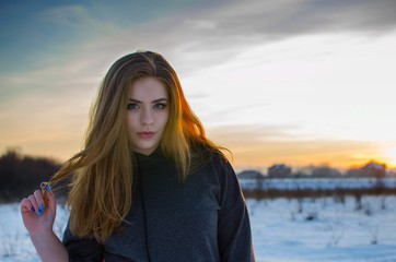Young smiling girl in the winter in the open air