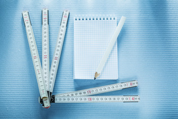Notebook pencil measuring tape construction concept