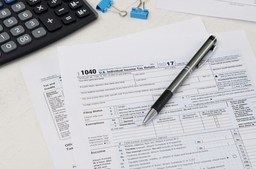 Obraz premium US tax form 1040 with pen and calculator