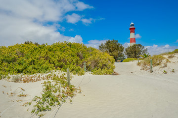 Scenic red and white Moore Lighthouse Point on blue sky in Geraldton, Western Australia, from...