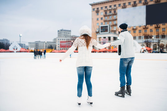 Love couple learn to skate on the rink