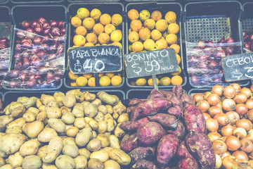 Market stall with tropical fruits and vegetables.