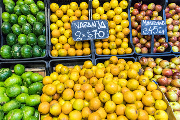 Market stall with tropical fruits and vegetables.