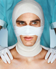 Men's face in medical bandage after beauty Plastic Surgery. Beauty concept