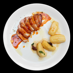 Duck fillet with apples and orange sauce, black background