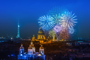 Salute above St. Petersburg. Holidays in Russia. View of St. Isaac's Cathedral in St. Petersburg. Panorama of fireworks over the city. Celebration in St. Petersburg.