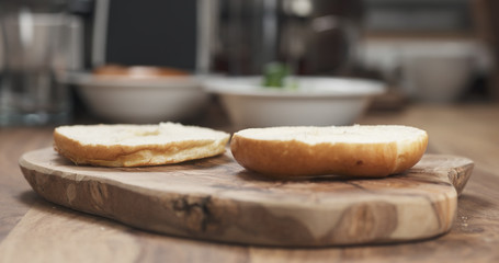 sliced bagel on wood board