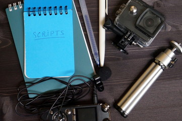 Video blogger accessories and scratchpad with script. Preparing for video shooting
