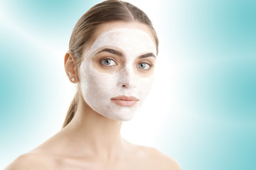 Young woman with beauty mask on her face