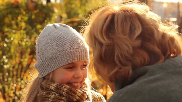 Happiness of meeting granddaughter with grandmother, hugg in fall park