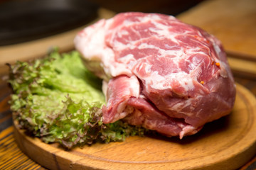 Raw pork meat on wooden cutting board