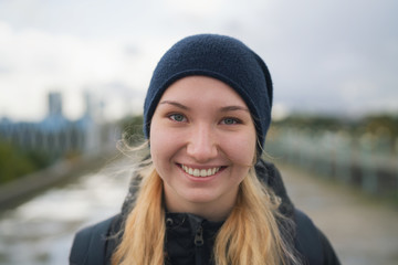 urban portrait of teen girl walking in the city in autumn or spring