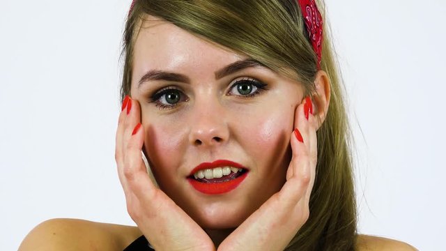 A beautiful 50s pin-up girl with a surprised expression - face closeup - white screen background