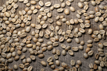 Unroasted  green coffee beans on wooden background - Close up