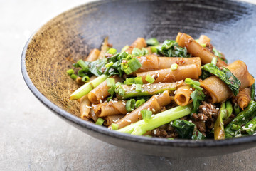 Thai Pad See Ew Noodles with vegetable and minced beef as close-up in a bowl